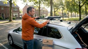 Man bekijkt accessoires van de dakdrager bij zijn auto